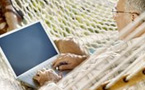 man with a laptop in a hammock